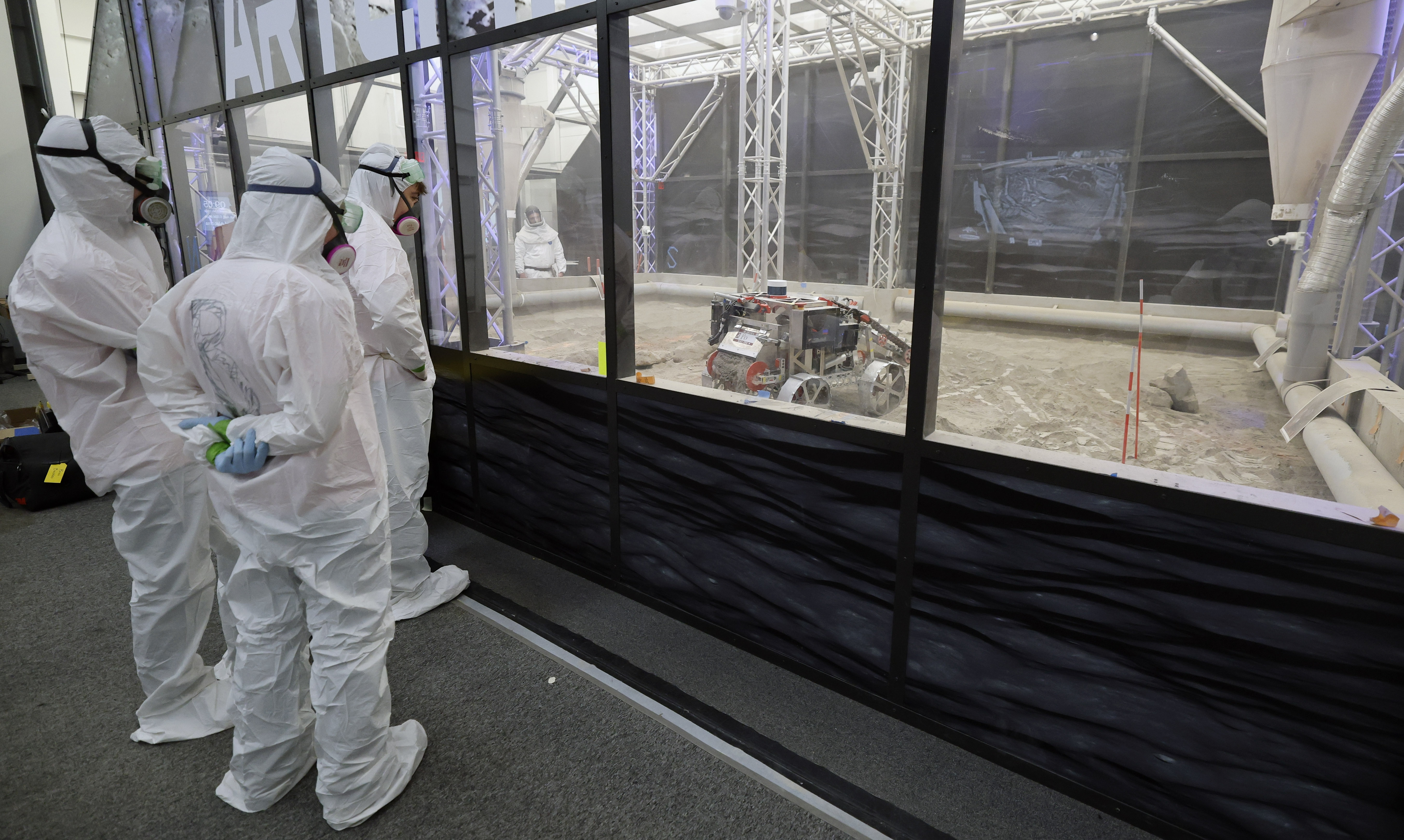 University of Alabama team members watch their robot make a...
