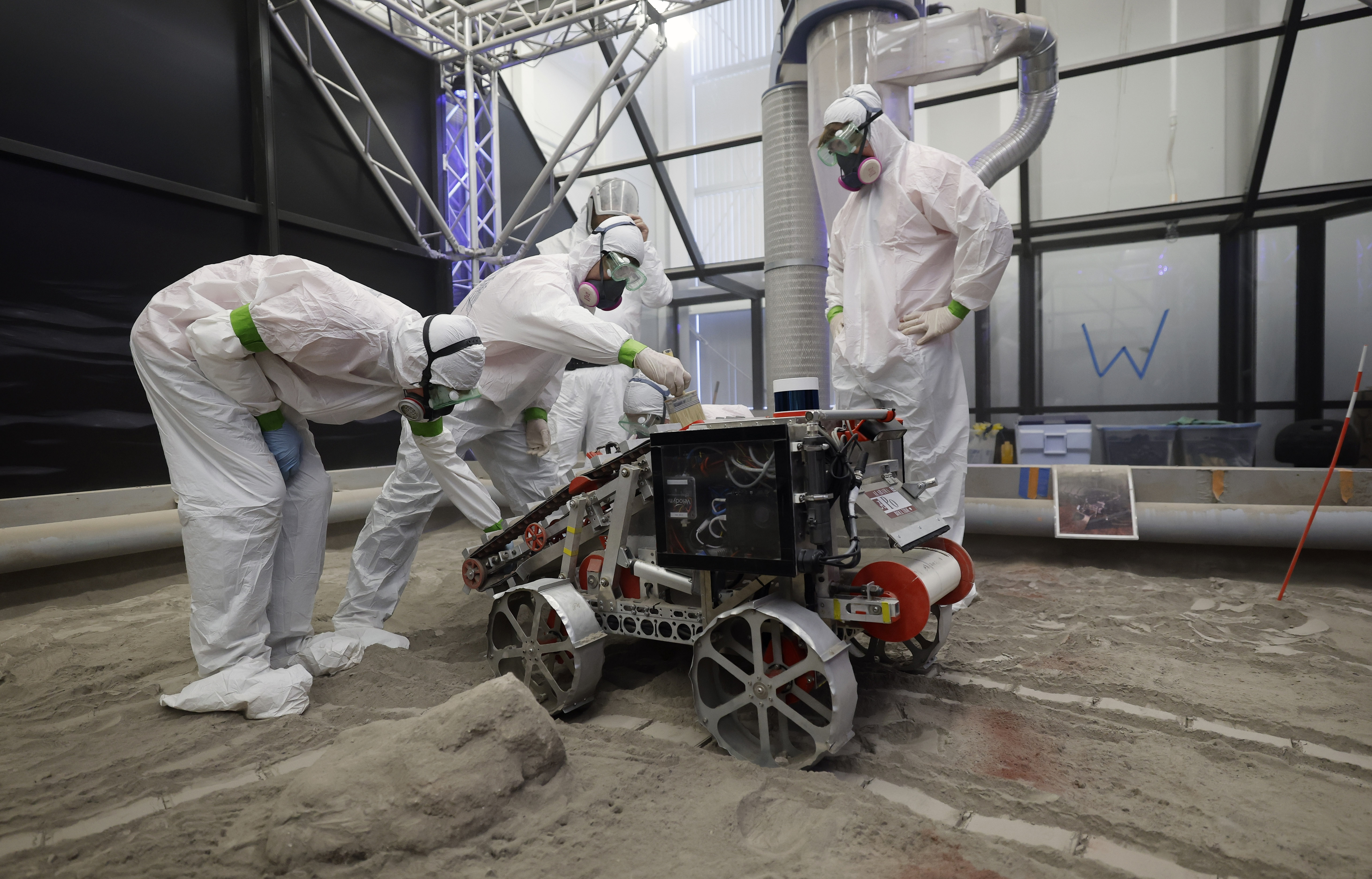 University of Alabama team members clean their robot after competing...