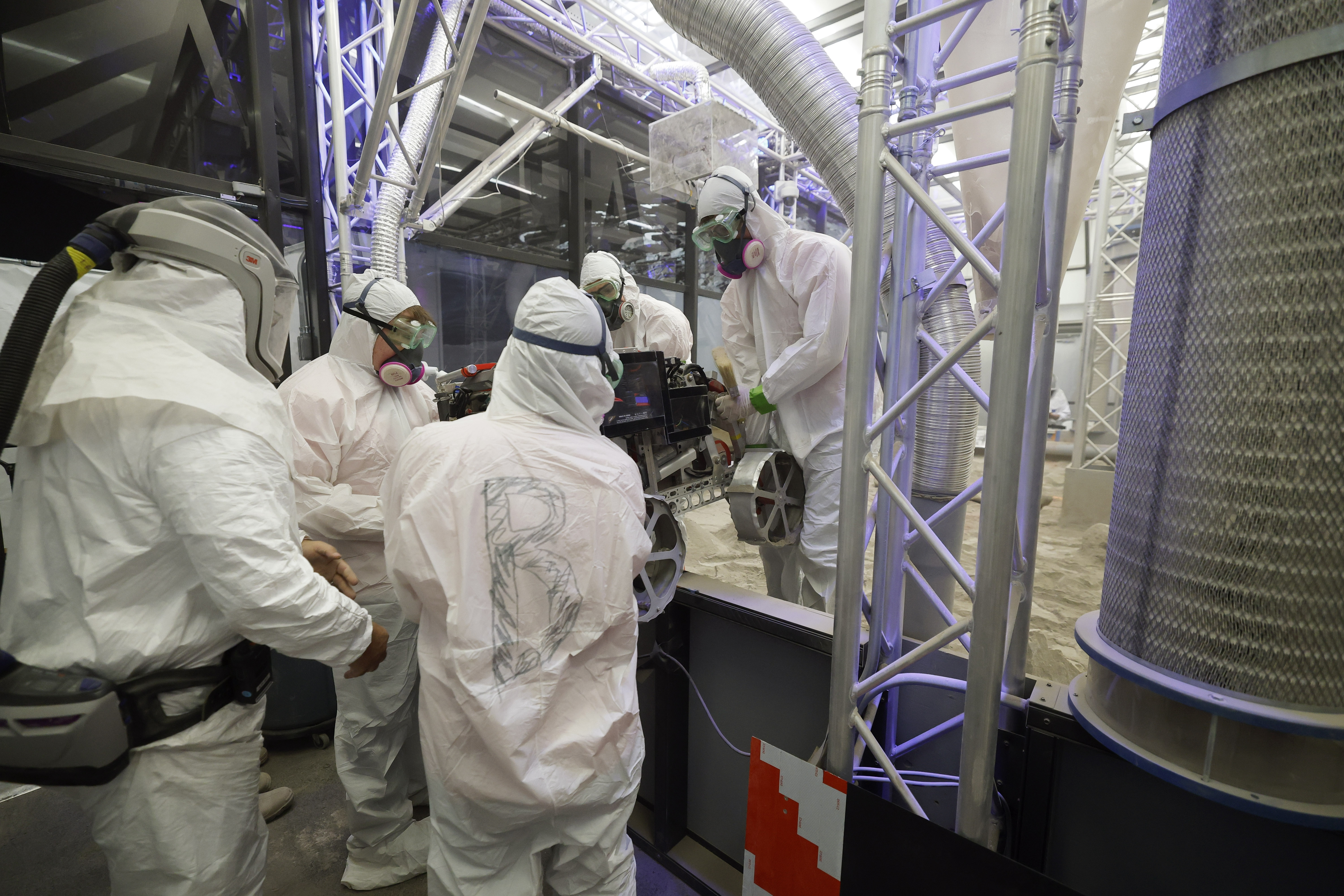 University of Alabama team members take their robot out of...