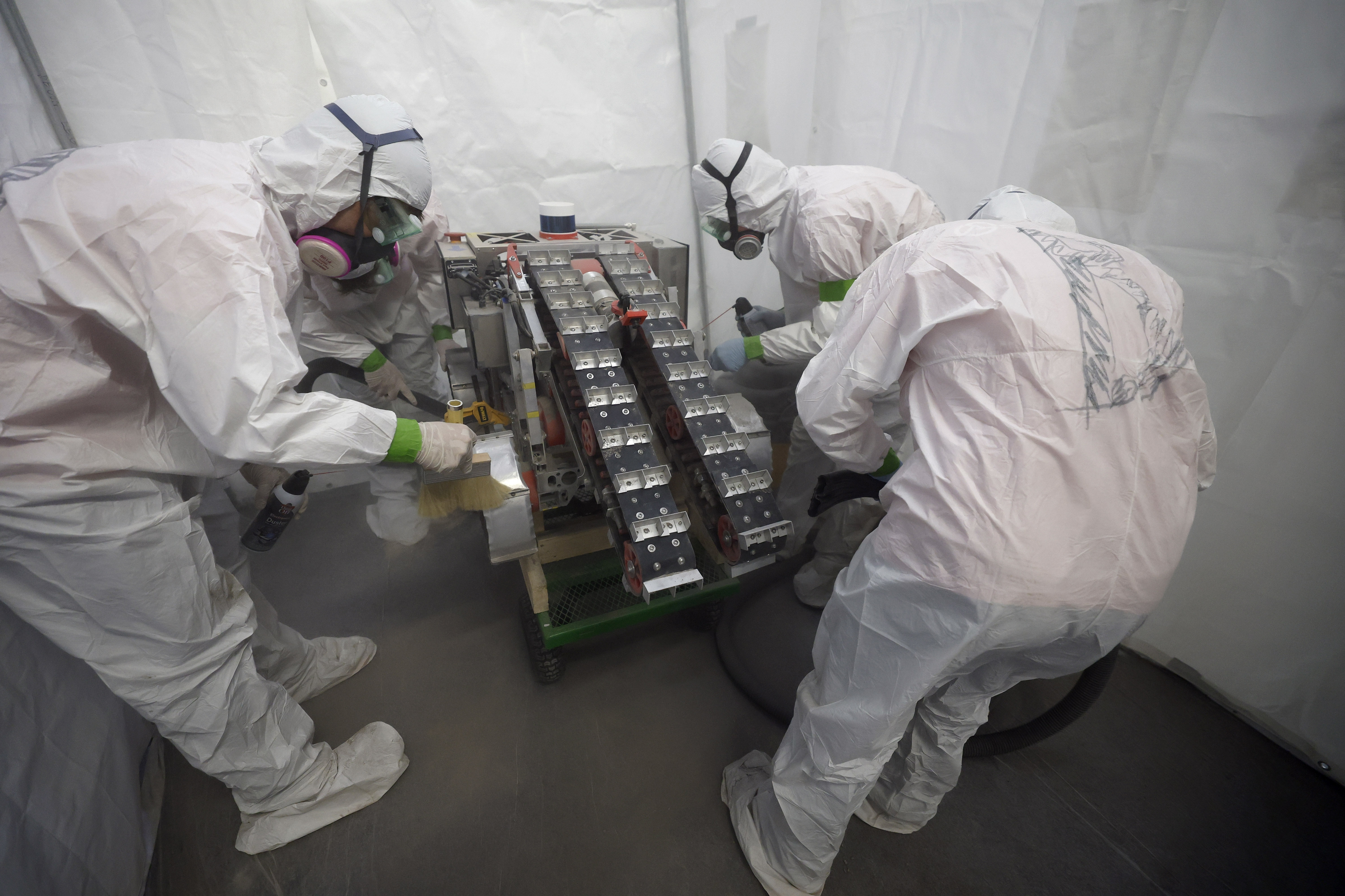 University of Alabama team members clean their robot after competing...