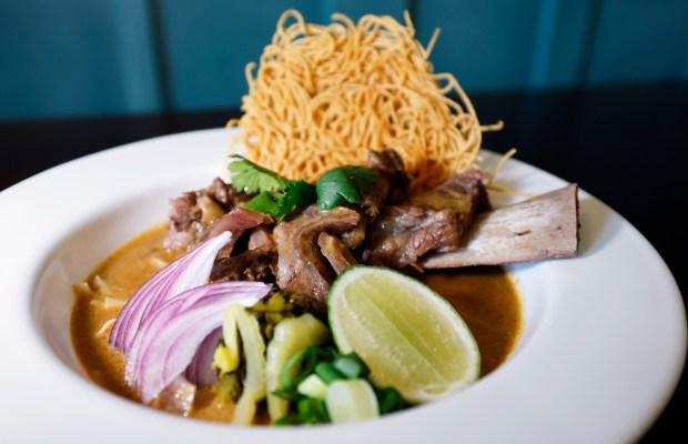 Braised Short Rib Khao Soi "Northern Thai curry noodle soup with egg noodles in coconut curry broth, topped with crispy noodles, pickled mustard greens, shallots, chili, and lime" Thai dishes at Noods, at Thai restaurant in MetroWest, on Monday, May 11, 2026. (Ricardo Ramirez Buxeda/ Orlando Sentinel)
