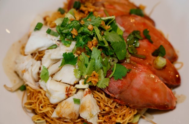 BBQ Pork & Crab Egg Noodles -- Dry "Egg noodles topped with BBQ pork and crab meat, served dry with savory sauce and aromatic garnishes" Thai dishes at Noods, at Thai restaurant in MetroWest, on Monday, May 11, 2026. (Ricardo Ramirez Buxeda/ Orlando Sentinel)
