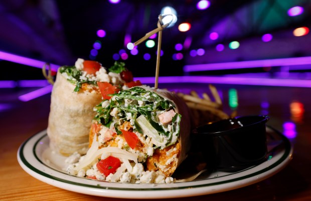 Buffalo Chicken Wrap "crispy or grilled chicken, jack cheese, romaine, tomatoes, and blue cheese ranch" is among the food offerings at Primrose Lanes, on Tuesday, May 12, 2026. (Ricardo Ramirez Buxeda/ Orlando Sentinel)