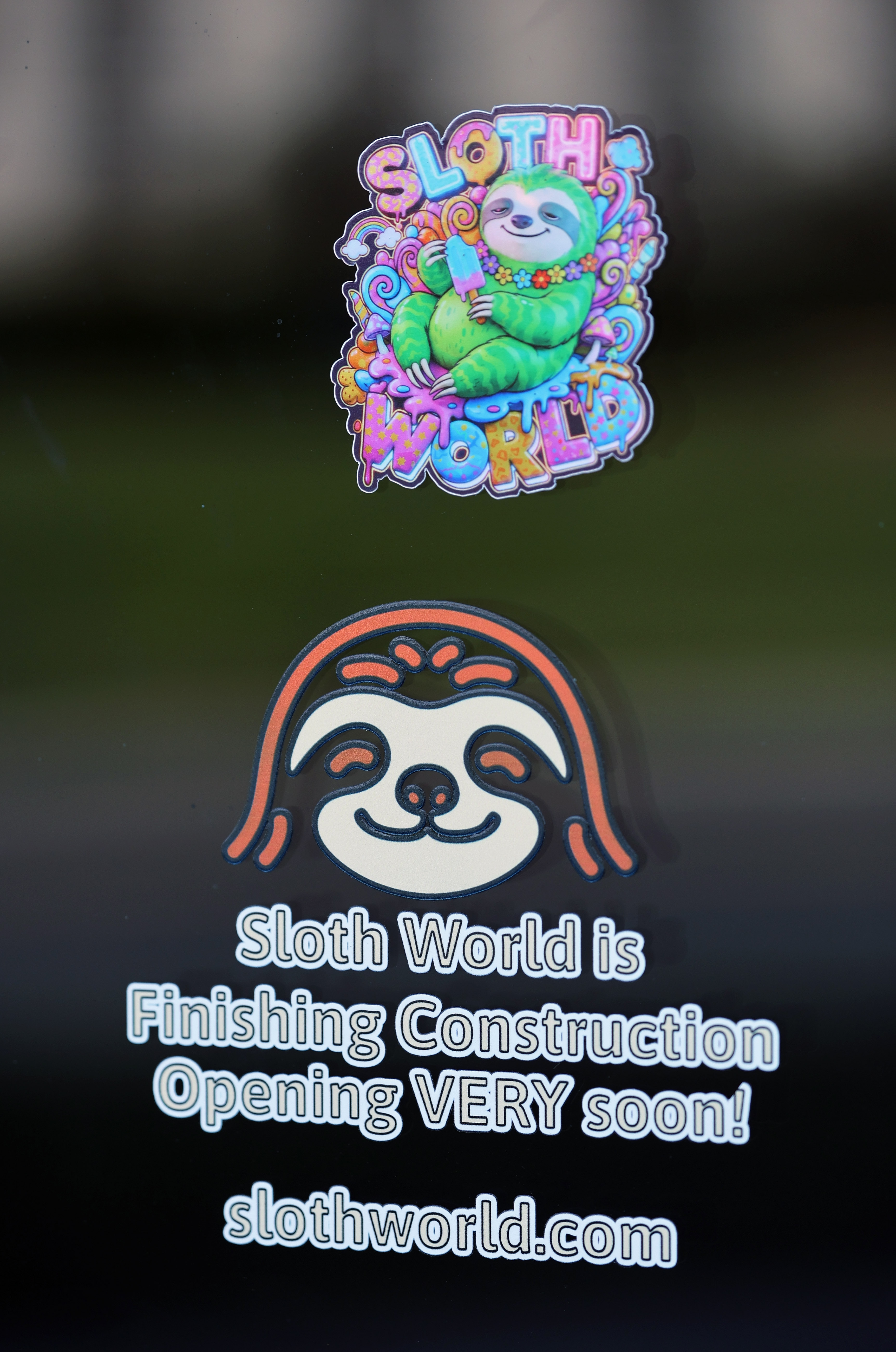 Sticker on the outside windows of Sloth World on International...