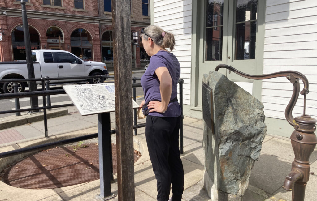 An East Coast visitor pauses in downtown Jacksonville to read one of the town’s interpretive storyboards— part of its “Museum without Walls,” where history unfolds not inside a single building, but along the streets themselves. Photo: Jim Flint.