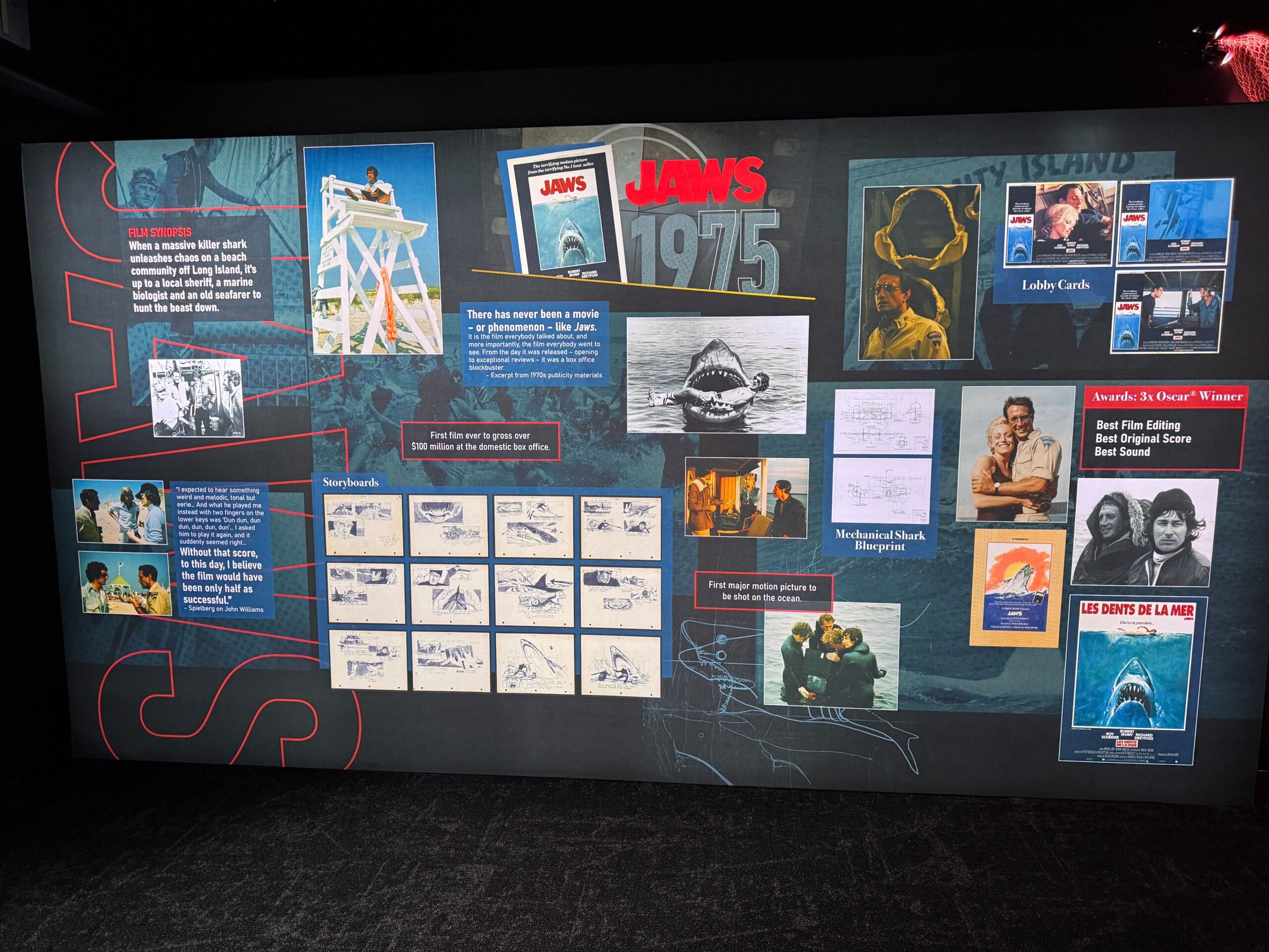 The experience begins with the summer blockbuster that started it all: Jaws. A mural includes storyboards, behind-the-scenes photos, lobby cards, posters, stills, and a blueprint for the mechanical shark alongside quotes and facts about the film. Released in 1975, Jaws was the first film to ever gross $100 million at the domestic box office.