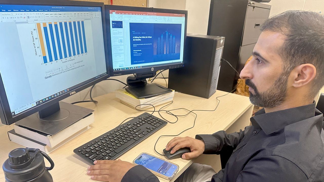Mohammed Almasabi, a transportation engineering PhD candidate at the University of South Florida, goes over data connected to an advanced air mobility system being developed by a team at the school. (Spectrum News/Sarah Blazonis)