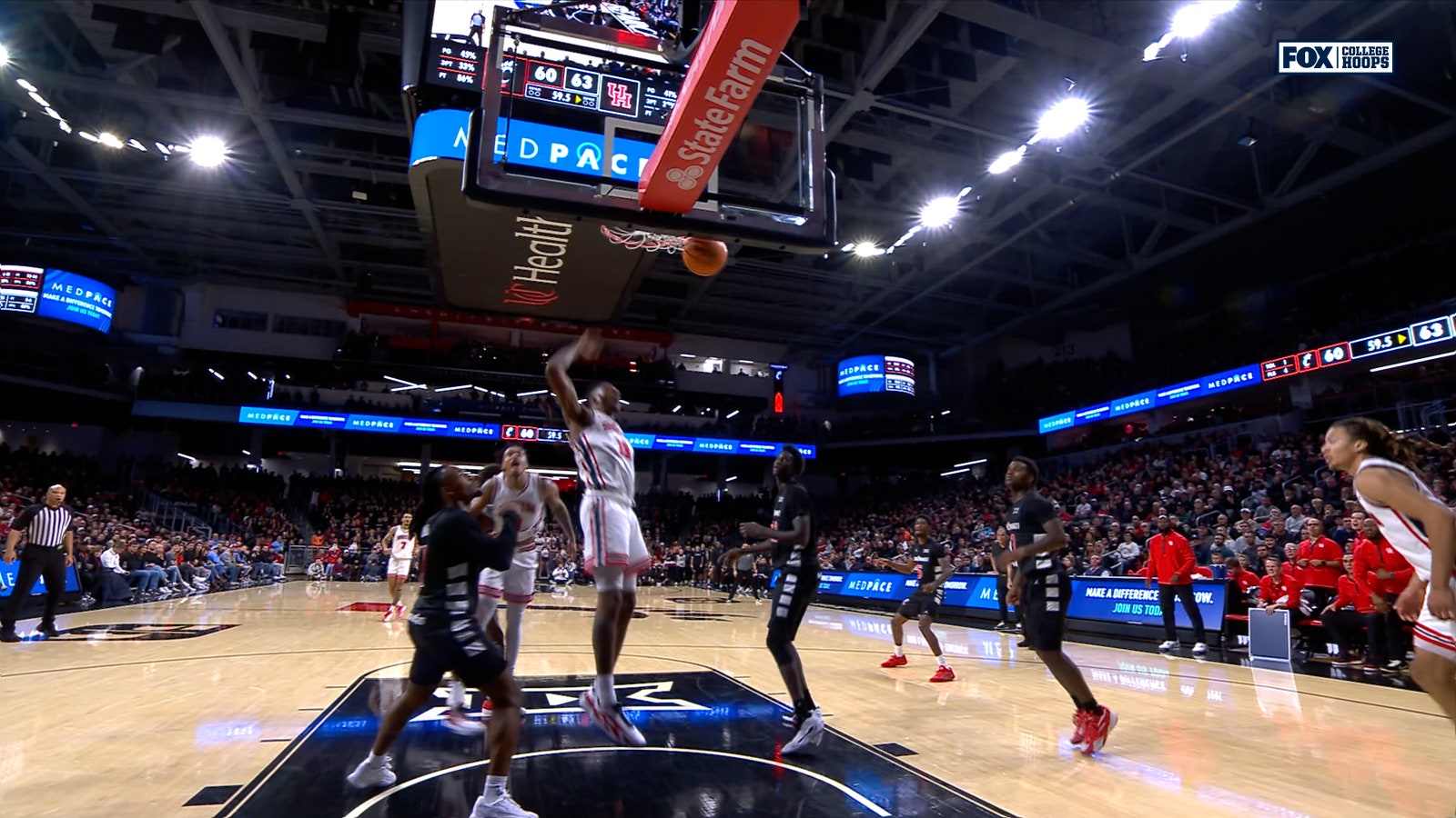 Houston's Joseph Tugler throws down a putback dunk against Cincinnati 