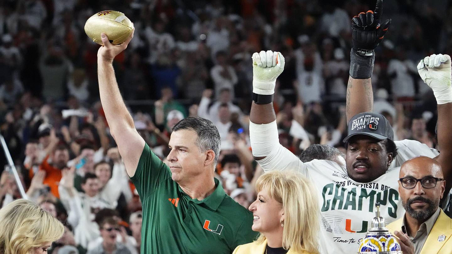 Miami Hurricanes head coach Mario Cristobal lifts the trophy after defeating Ole Miss 31-27 in the Vrbo Fiesta Bowl and CFP semifinal game at State Farm Stadium on Jan. 8, 2026, in Glendale.