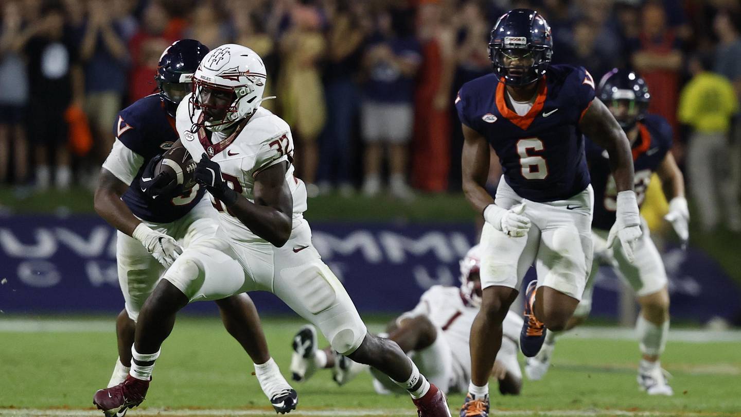 Sep 26, 2025; Charlottesville, Virginia, USA; Florida State Seminoles running back Ousmane Kromah (32) carries the ball past Virginia Cavaliers defensive end Cazeem Moore (6) at Scott Stadium. Mandatory Credit: Geoff Burke-Imagn Images