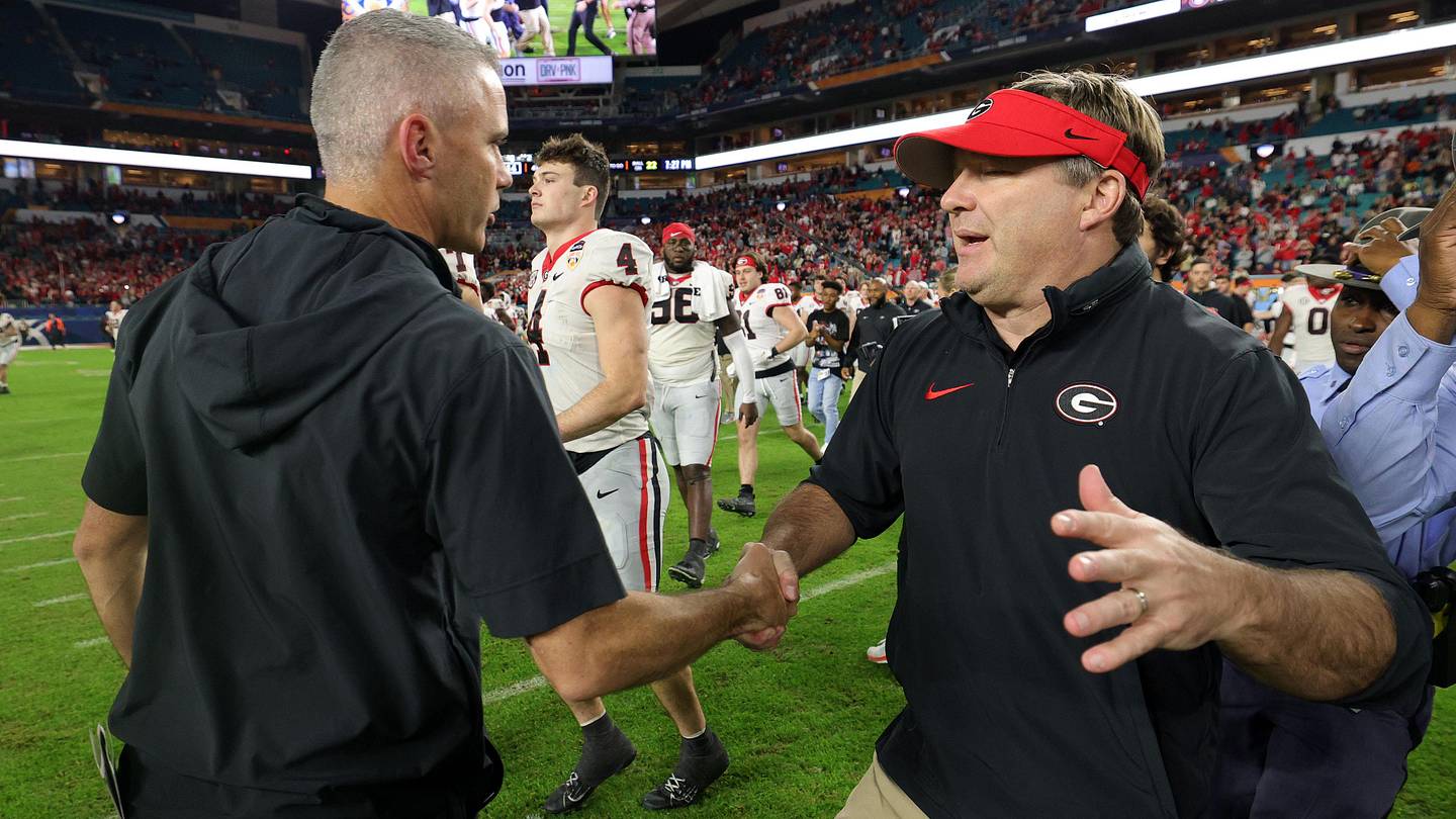 Georgia Bulldogs head coach Kirby Smart (right) shakes hands with Florida State Seminoles head coach Mike Norvell (left)