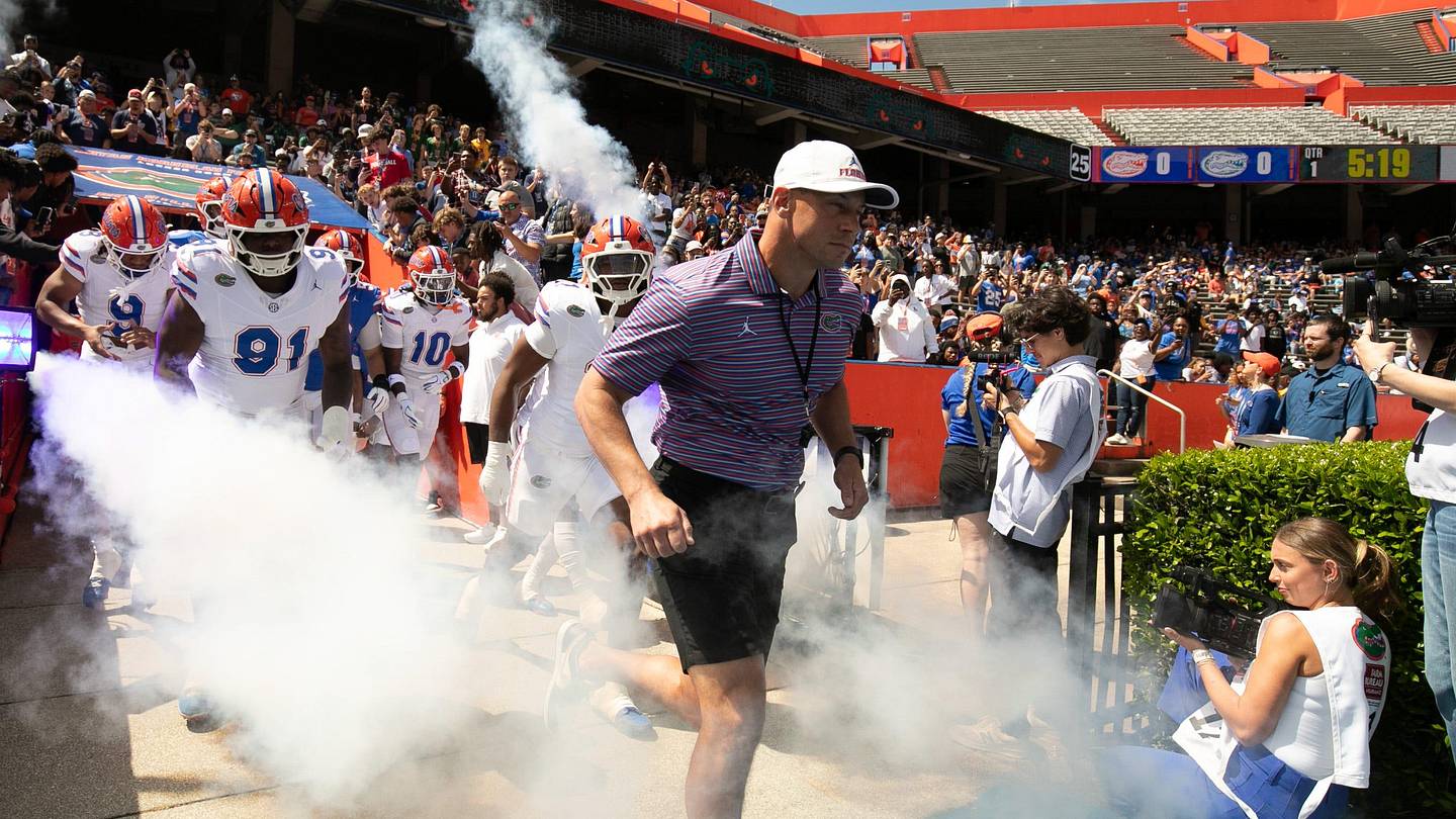 Florida head coach Jon Sumrall and the team blasts out onto the field before the Orange and Blue game at Steve Spurrier Field at Ben Hill Griffin Stadium in Gainesville, FL on Saturday, April 11, 2026. [Alan Youngblood/Gainesville Sun]