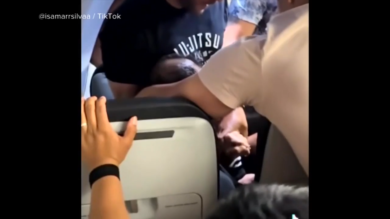 Unruly passenger arrested at MIA after trying to pry open exit doors, choking off-duty flight attendant, police say - WSVN 7News | Miami News, Weather, Sports