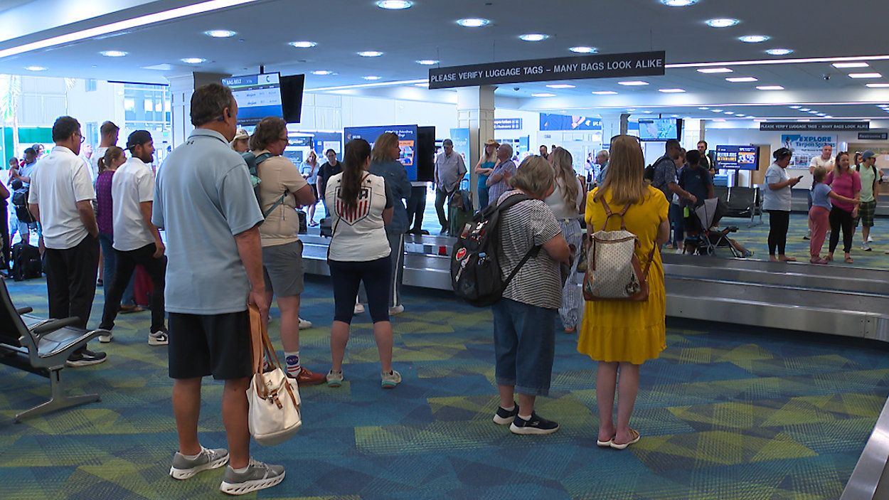 Passengers picking up their suitcases in the bag terminal at St.Pete-Clearwater Airport. (Spectrum News)