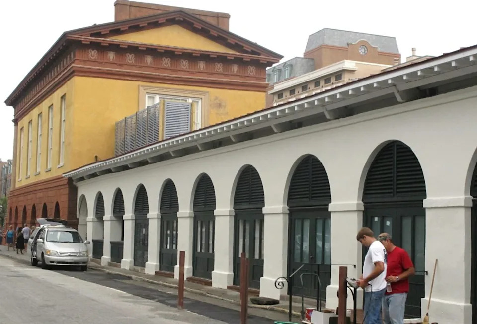 In this photo taken June 24, 2011, workers put some finishing touches on the outside of the Charleston City Market in Charleston, South Carolina, after a $5.5 million renovation. (AP Photo/Bruce Smith)