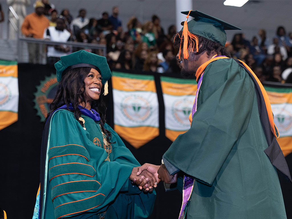 Florida A&M University President Marva Johnson, J.D., congratulates a graduating engineering student during the Spring 2026 Commencement Ceremony.(Photo courtesy Christian Whitaker)