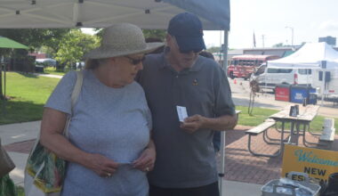 New residents Helma Borg (left) and Bert Borg look at promotional items during the 2025 New Resident Welcome Party. This year's welcome party will be June 12, during Jacksonville Main Street's Downtown Concert Series.