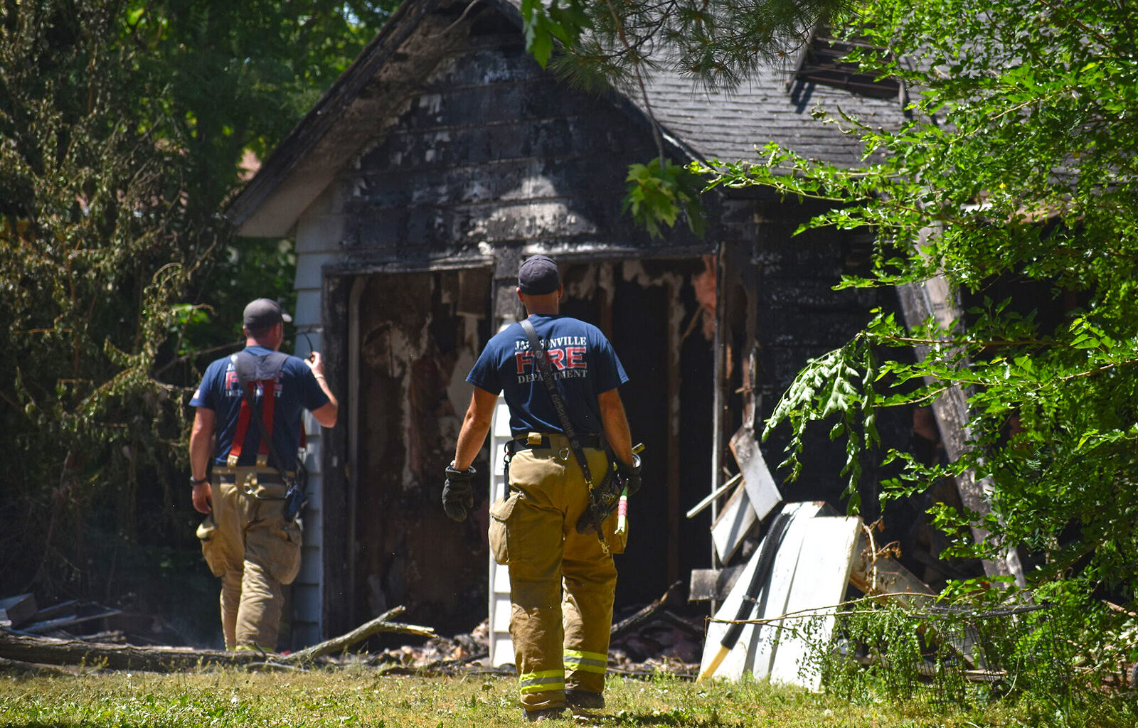 Jacksonville firefighters check for any rekindling of a fire at 731 N. Main St. A fire started inside the garage about 6:30 a.m. Wednesday and firefighters returned two more times because of smoke.