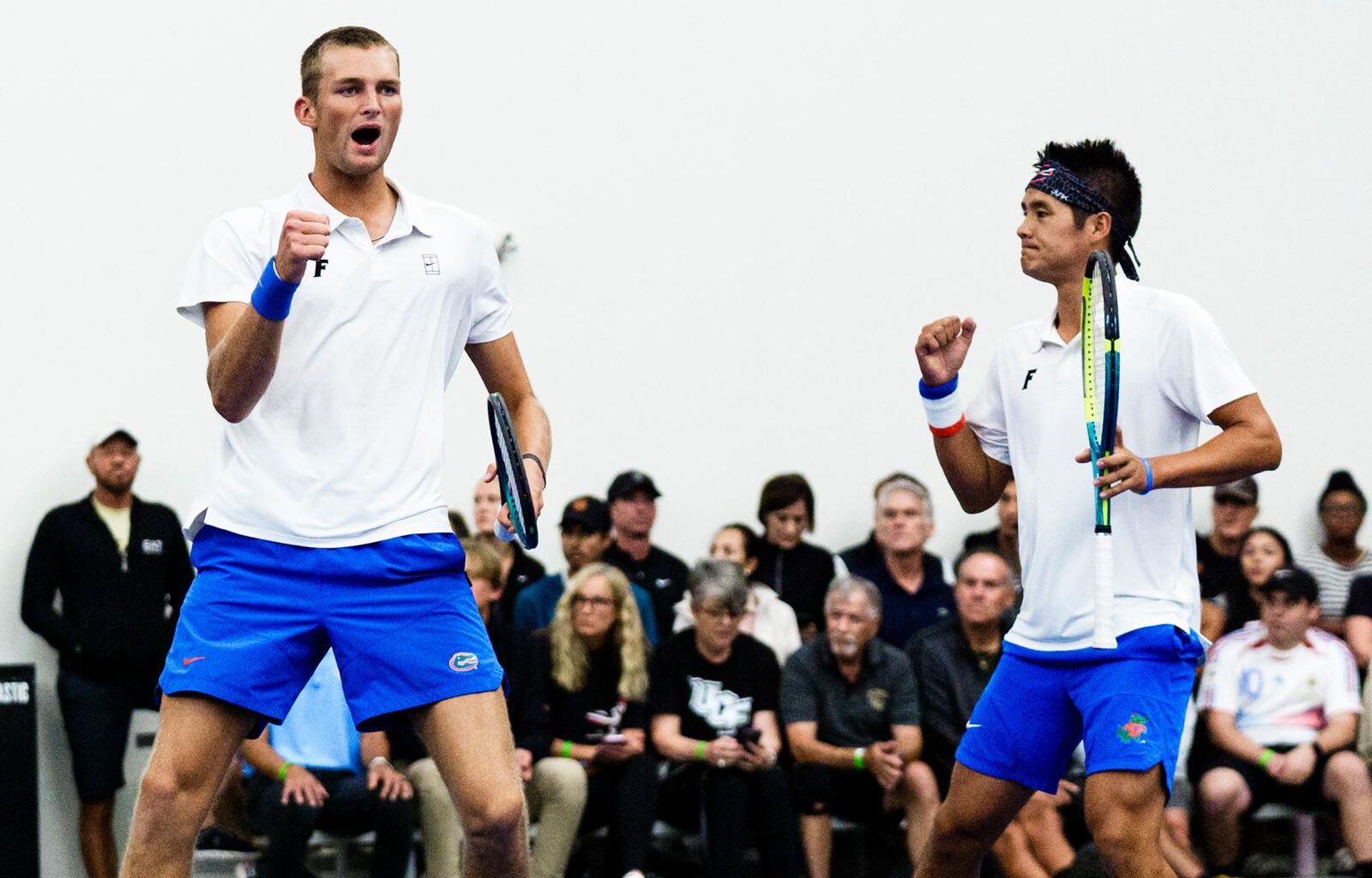 Tanapatt Nirundorn tossing the tennis ball in the air for his serve in doubles against UCF in NCAA Second Round.