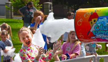 Mavis Mudd, 6, the daughter of Jonathan and Katie Mudd, plays in foam during the opening party for Jacksonville Public Library's youth summer reading program. 