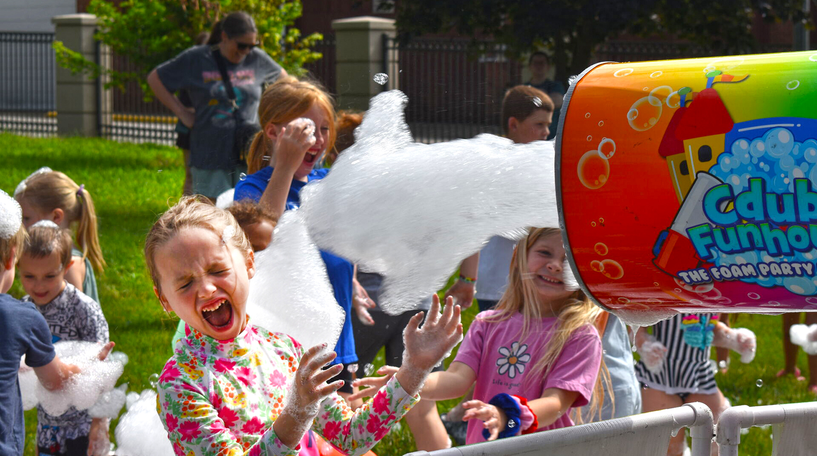 Mavis Mudd, 6, the daughter of Jonathan and Katie Mudd, plays in foam during the opening party for Jacksonville Public Library's youth summer reading program. 