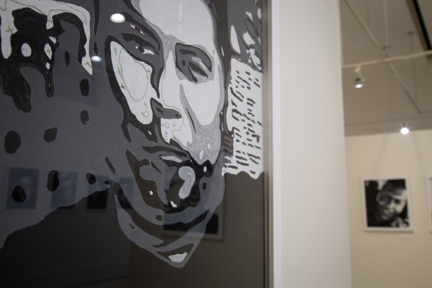 A portrait of Miguel Angel Honorato, one of the 49 people killed in the Pulse nightclub shooting in 2016, hangs at Orlando City Hall’s Terrace Gallery. His is one of several portraits in the exhibit that remain partially unfinished.