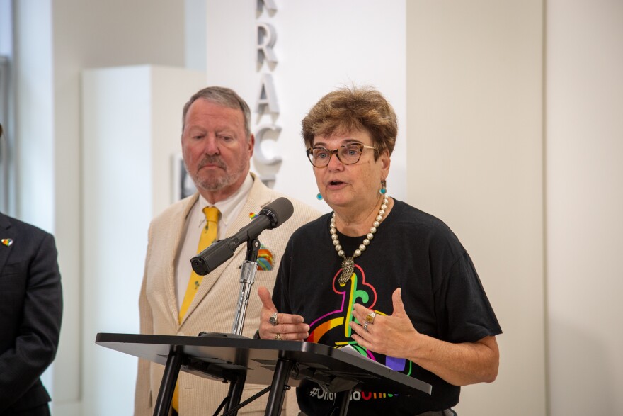 Orlando Mayor Buddy Dyer and District 4 Commissioner Patty Sheehan speak to reporters in front of the Terrace Gallery at City Hall, where a traveling Pulse memorial is on display through August 23.