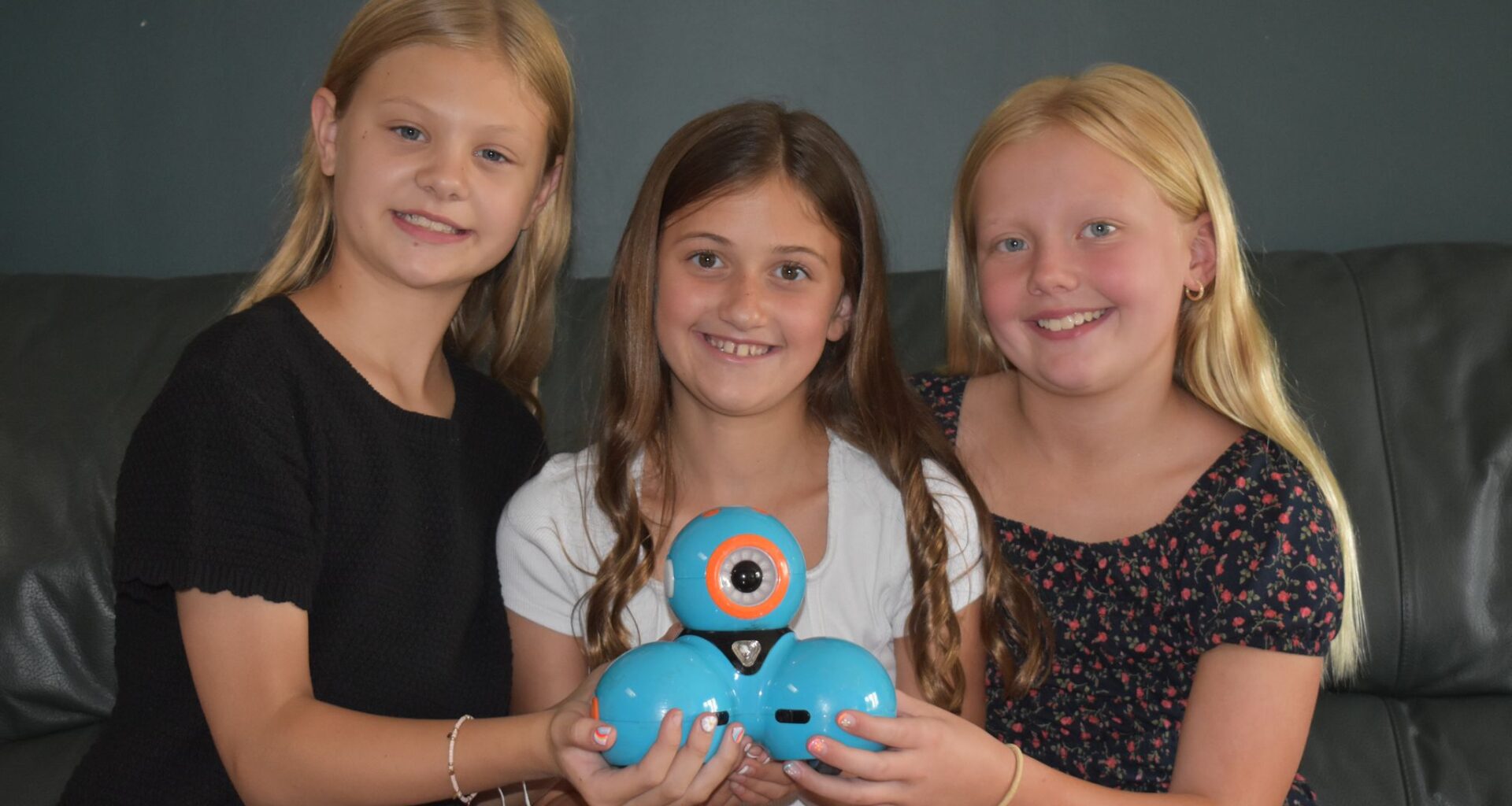 Claire Bruce (from left), Vivian Dobson and Elly Bumgarner hold a Dash robot from Wonder Robotics. The three Eisenhower Elementary students were named runners-up in the company's 2026 Wonder League Robotics Competiton.