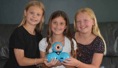 Claire Bruce (from left), Vivian Dobson and Elly Bumgarner hold a Dash robot from Wonder Robotics. The three Eisenhower Elementary students were named runners-up in the company's 2026 Wonder League Robotics Competiton.