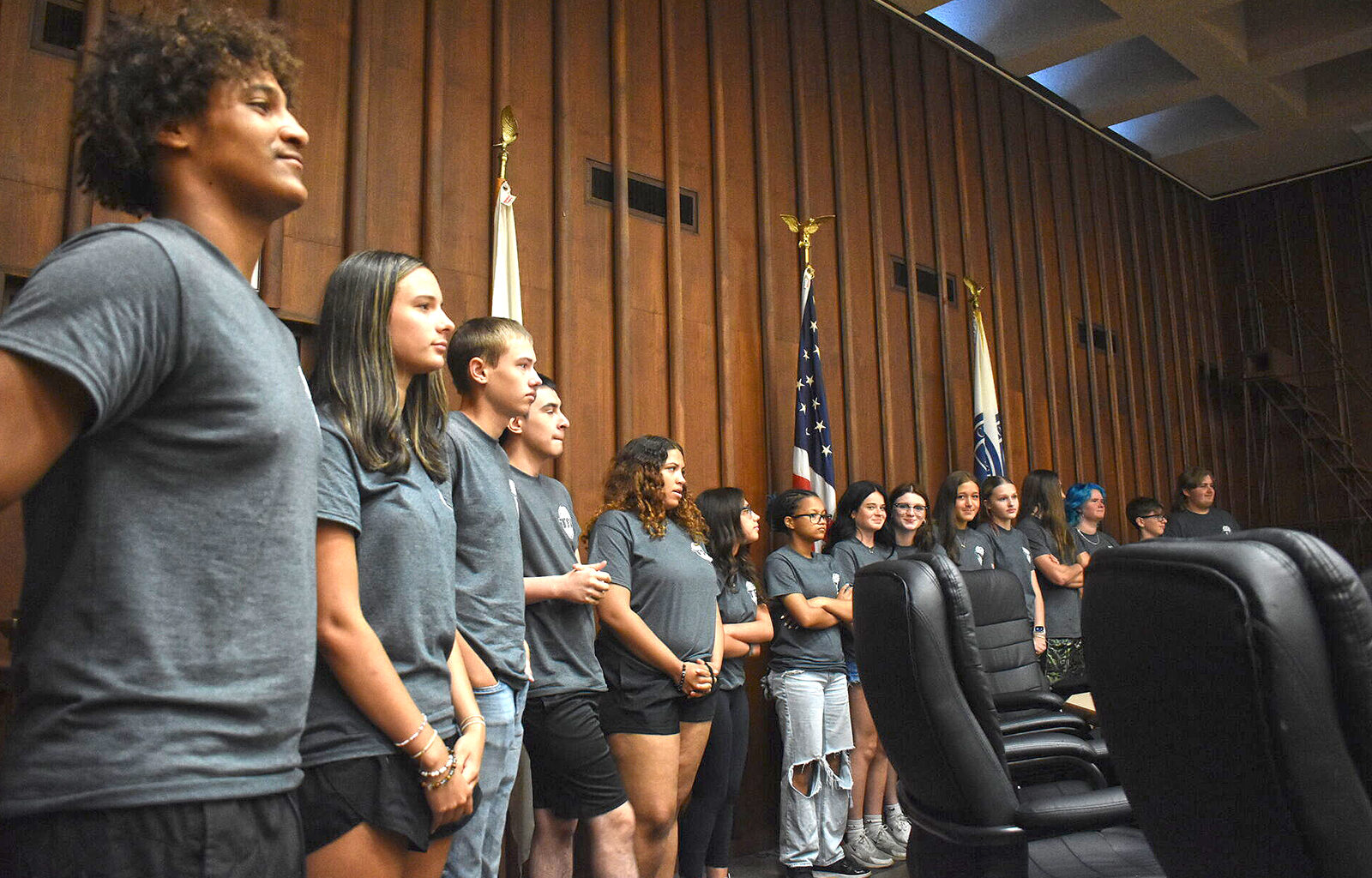 Students in the Jacksonville Police Department's Teen Police Academy line up while they wait for their names to be called during a graduation ceremony.