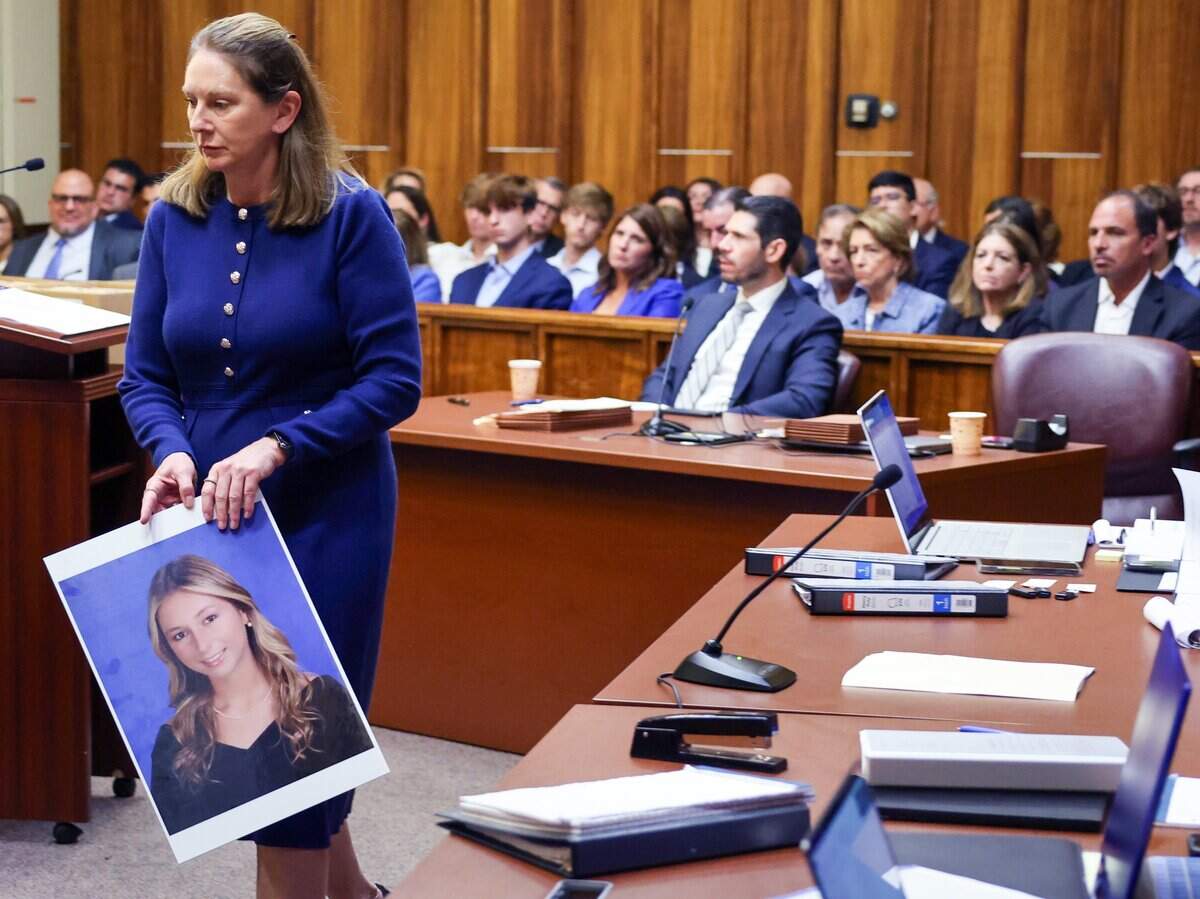 Prosecutor Laura Adams walks with a photo of Lucy Fernandez prior to giving the state’s opening statement in the trial of George Pino on Monday, June 8, 2026, in Miami. Pino is charged in connection to the boat crash that killed 17-year-old Lucy Fernandez in 2022.