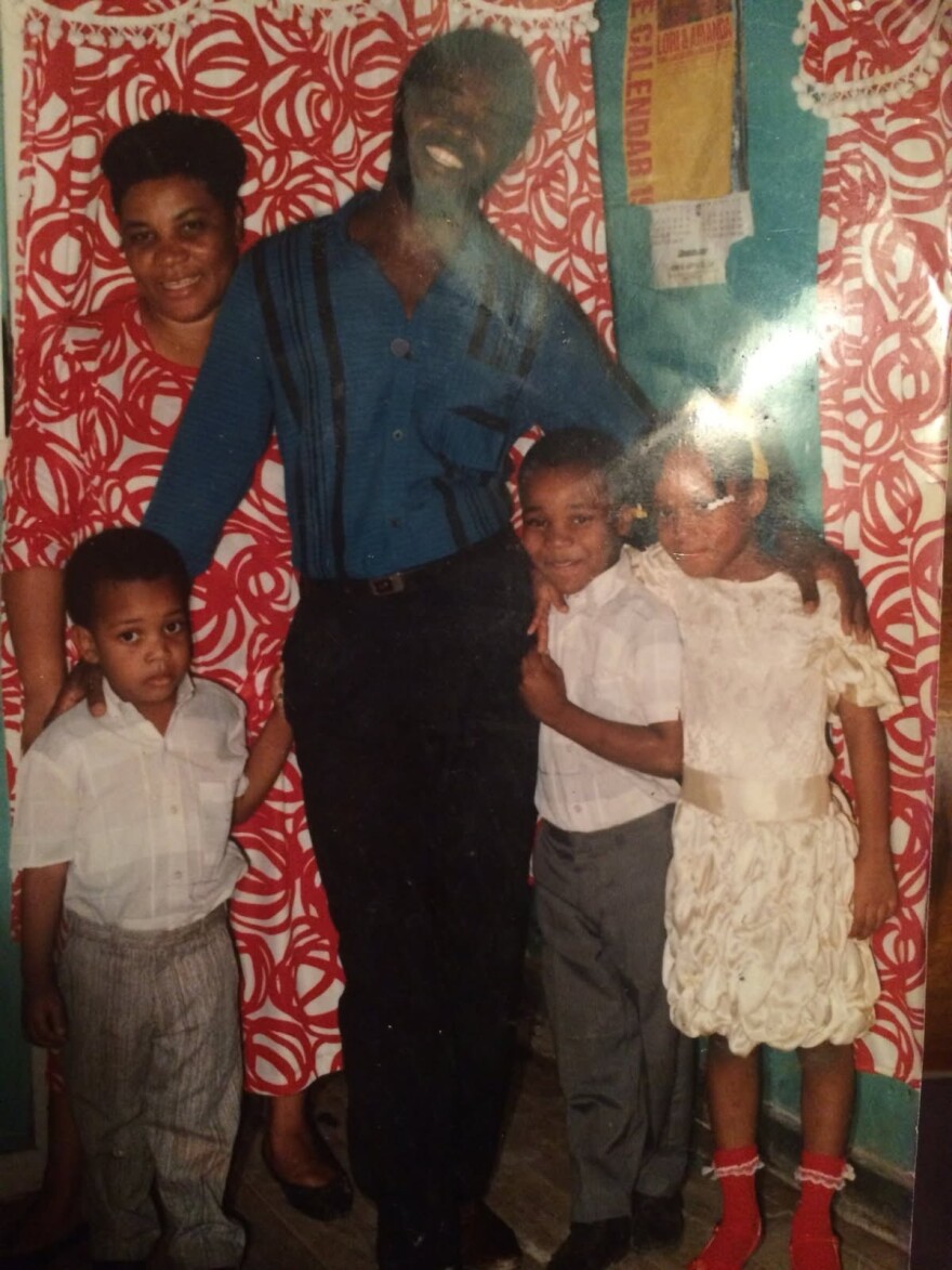 Ludie Charles, far right, stands with her two brothers, mother and father in Haiti.