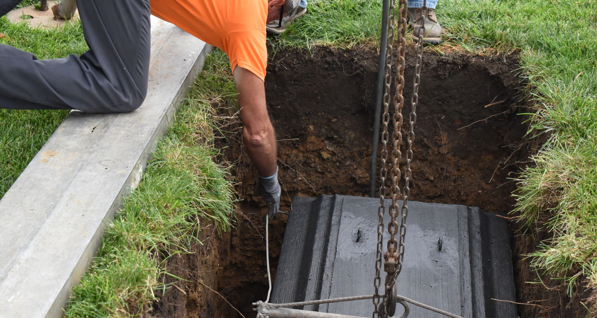 Rex Vault staff lower Jacksonville's bicentennial time capsule into a hole Wednesday near the Jacksonville Municipal Building. The time capsule will call the plot home for the next 50 years.
