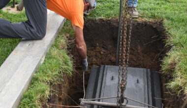 Rex Vault staff lower Jacksonville's bicentennial time capsule into a hole Wednesday near the Jacksonville Municipal Building. The time capsule will call the plot home for the next 50 years.
