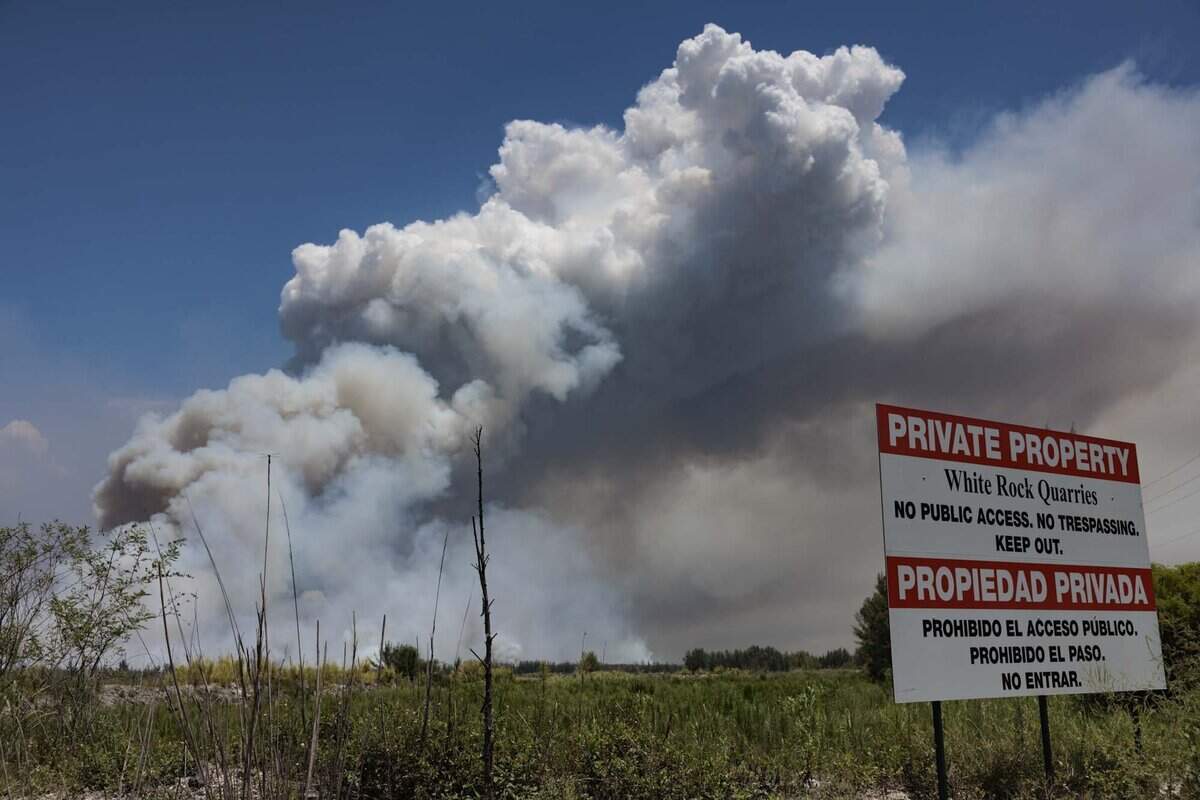 Smoke rises during a brush fire on Wednesday, June 17, 2026, in west Miami-Dade just west of Doral.