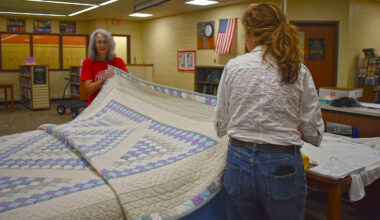 River Country Quilt Guild member Theresa Sauer (left) and volunteer Kathy Korte display a quilt during the River Country Quilt Show's bed turning. Organizers are accepting entries for quilts to display during this year's show at Jacksonville High School.