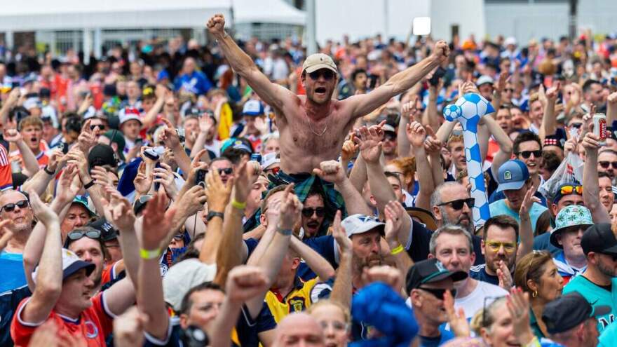 A large crowd with their hands in the air