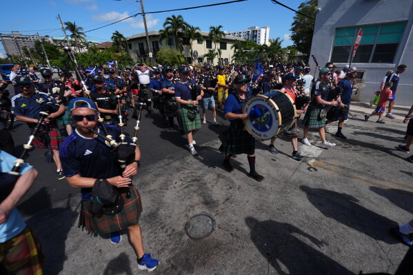 Scotland soccer fans march with the Tartan Army from Miami's Little Havana neighborhood on their way to a Miami Marlins against the Texas Rangers baseball game, Monday, June 22, 2026. (AP Photo/Rebecca Blackwell)
