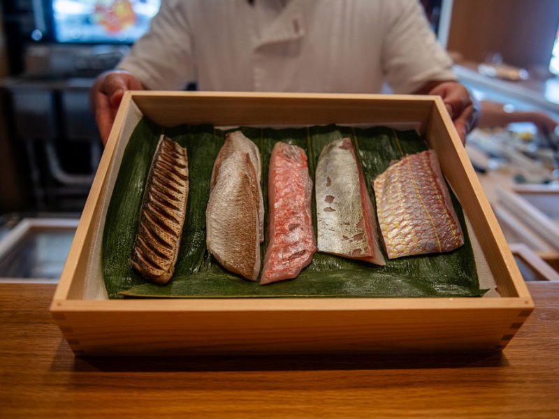 Chefs at Okonomi inside Mills Market shape bites from rare cuts of fish