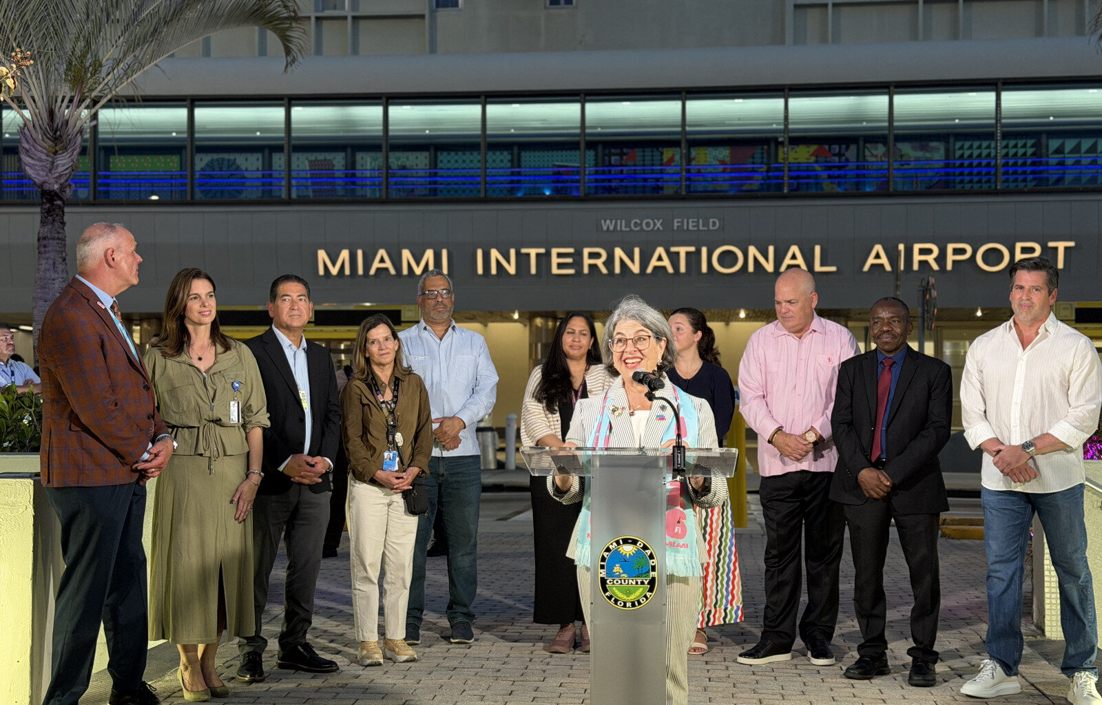 Miami-Dade County Mayor Daniella Levine Cava (center) with members of the Forward Flight team at the unveiling of MIA&rsquo;s lighting and beautification efforts for the FIFA 2026 World Cup.