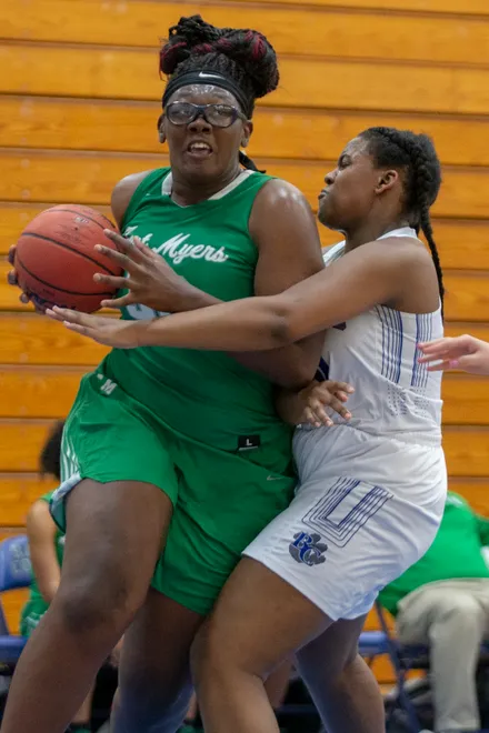 Fort Myers's Chaniya Clark takes the ball to the hoop while defended by Barron Collier's Madisyn Walker during the Class 7A regional semifinals game, Tuesday, Feb. 19, 2019, at Barron Collier High School in East Naples
