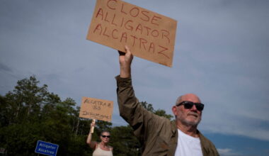 People attend a vigil at the entrance of "Alligator Alcatraz" ICE detention center in Ochopee