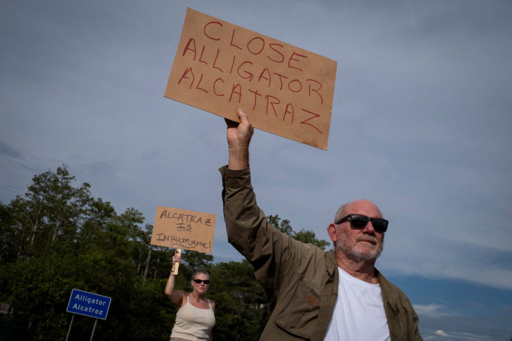 People attend a vigil at the entrance of "Alligator Alcatraz" ICE detention center in Ochopee