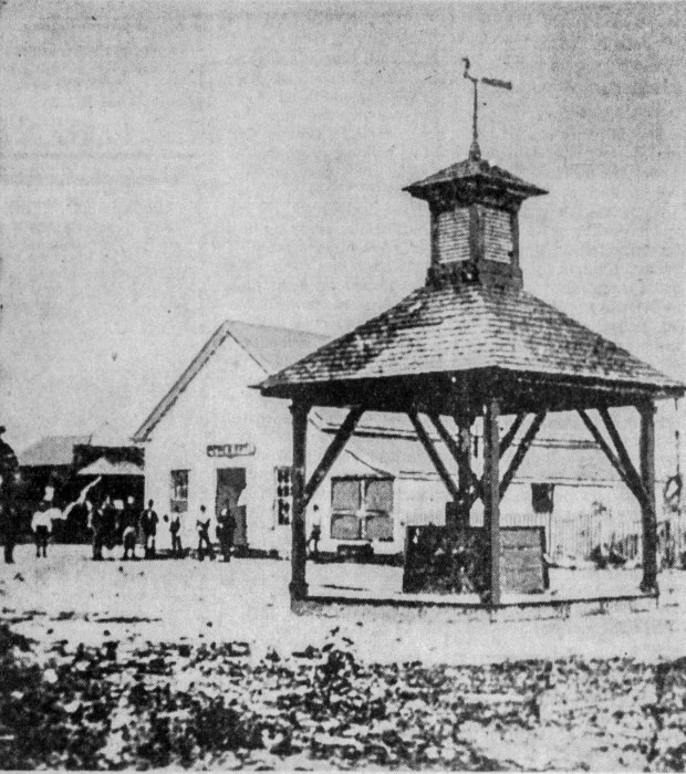 The building in the back of this photo was the home of the Orange County Reporter, which was destroyed by a fire in 1884, nearly wiping out editor and publisher Mahlon Gore. The structure in the foreground was Orlando's town well. (Orlando Sentinel File)