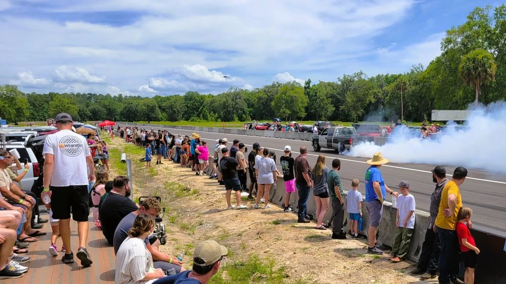 Cars do burnouts on the track of Hicken Power Dragstrip