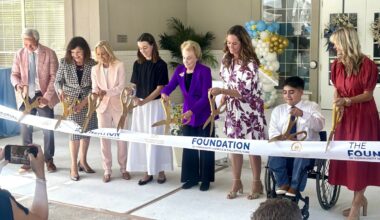 Dorothy Dorion, Mayor Donna Deegan and others cutting the ribbon to officially open the Dorion Family Pediatric Center