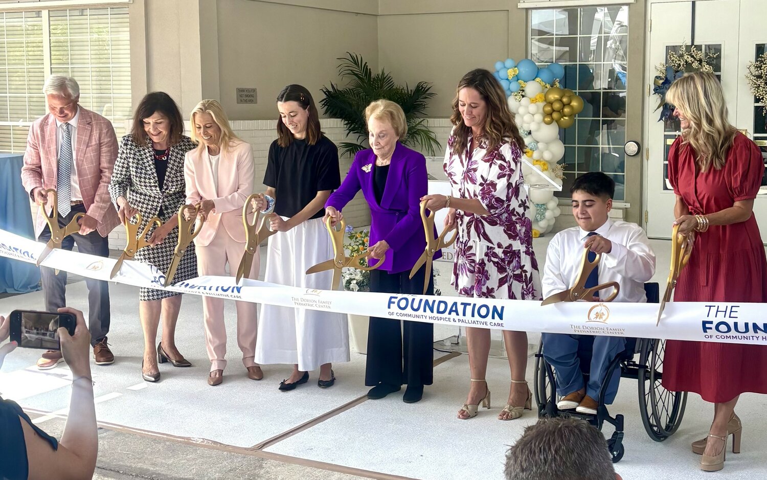 Dorothy Dorion, Mayor Donna Deegan and others cutting the ribbon to officially open the Dorion Family Pediatric Center