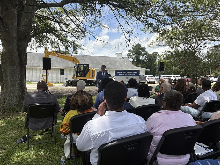 EPA regional administrator Kevin McOmber speaks about the agency’s involvement in the septic tank phase-out project.