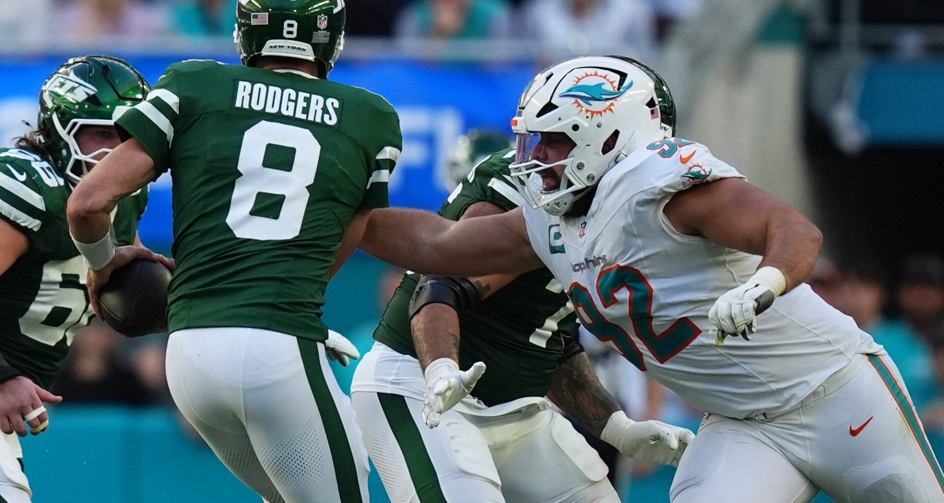 Miami Dolphins defensive tackle Zach Sieler (92) reaches for New York Jets quarterback Aaron Rodgers (8) during the second half at Hard Rock Stadium.