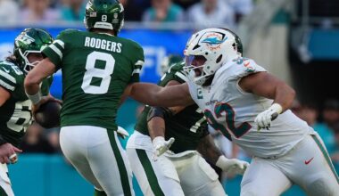 Miami Dolphins defensive tackle Zach Sieler (92) reaches for New York Jets quarterback Aaron Rodgers (8) during the second half at Hard Rock Stadium.